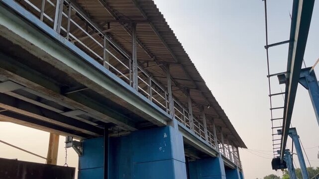Industrial building exterior with elevated walkway and metal roof