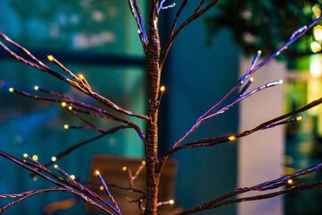 Decorative branches with tiny lights in dim lighting © Novanture