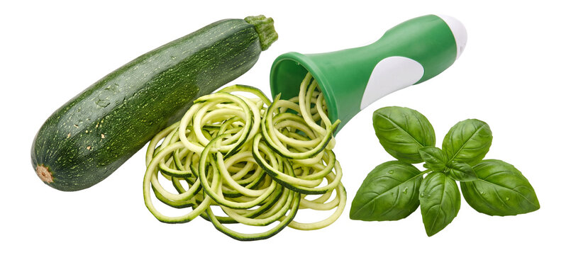 fresh zucchini noodles with a handheld spiralizer and basil