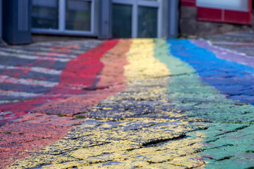 Painted Rainbow Crosswalk On Cracked Pavement Representing Pride, Diversity And Urban Street Art © Izanbar photos