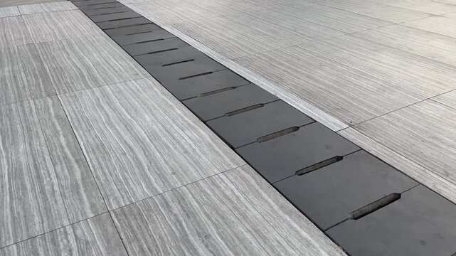 Concrete Trench Drain System on Elegant Linear Stone Pavement Background