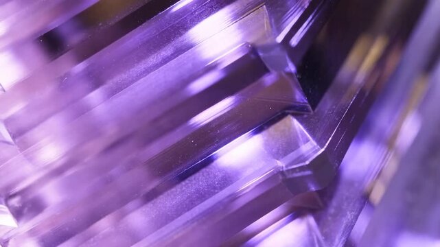 Purple Faceted Glass Prism Reflecting Light with Geometric Crystal Patterns