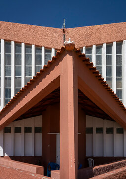 Terracotta tiled gable of the old Portuguese exhibition building topped with a dove ornament, Huila Province, Lubango, Angola