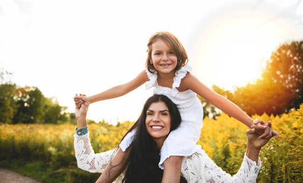 Mother having great moment with daughter on sunset time