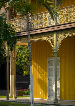 Ornate wrought-iron balcony of the Palacio de Ferro framed by a palm tree, Luanda Province, Luanda, Angola