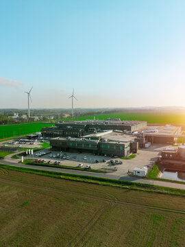 Large tech facility surrounded by open farmland fields
