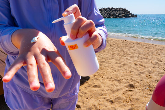 SPF, hands and girl on beach, sand and skincare for summer holiday in Korea