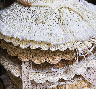 Close-up of layered handmade woven textiles with lace and natural fibers