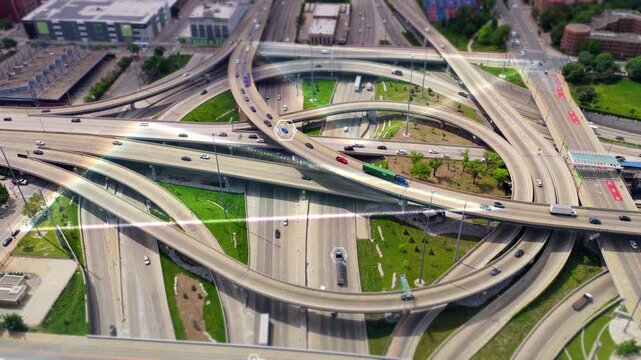 Smart city technology tracking autonomous vehicles with futuristic digital overlay on american highway interchange, data visualization and futuristic transportation network