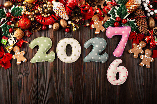 Christmas Ornaments and 2027 Numbers on Wooden Table