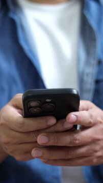 man holds smart phone in hands and scrolls through the news feed. Close up of hand uses mobile. point finger on screen, texting text message.	
