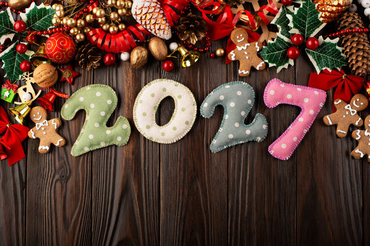2027 Felt Numbers with Christmas Decorations on Wooden Surface