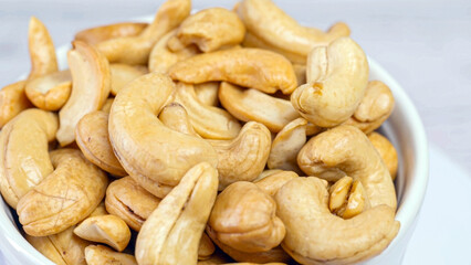 Fototapeta premium Fresh fried cashew nuts slowly rotating in a seamless loop