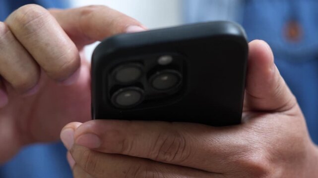 man holds smart phone in hands and scrolls through the news feed. Close up of hand uses mobile. point finger on screen, texting text message.	
