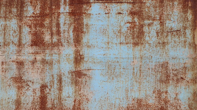 A close-up of a rusty metal texture. The image shows an old iron sheet covered with a layer of orange-brown rust and corrosion. Old, peeling blue paint shows through the layer of rust.