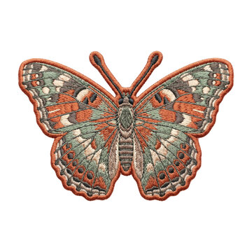 Embroidered butterfly patch isolated on transparent background. Vintage fabric insect badge with detailed orange, green and brown stitches. Textile cloth applique element.