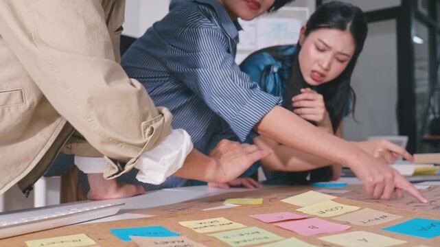 Business hands creating project mind map with colorful sticky notes