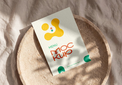 Paper menu card mockup on ceramic plate