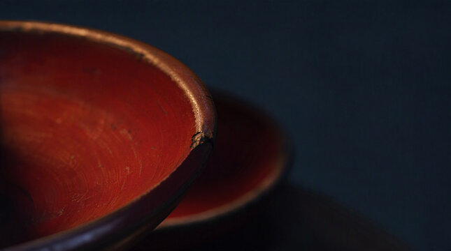 Macro of the worn rim of a Japanese red lacquer cup
