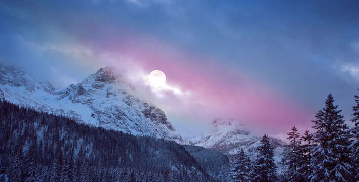 Full moon and abstract stars sky in a winter mountains.