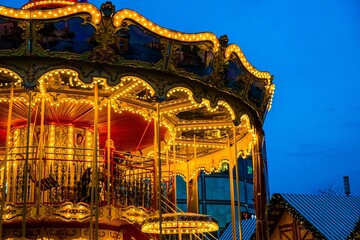 Brightly lit carousel at dusk © Novanture