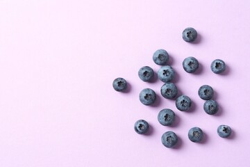 Fresh blueberries on violet background, top view © Sunlight