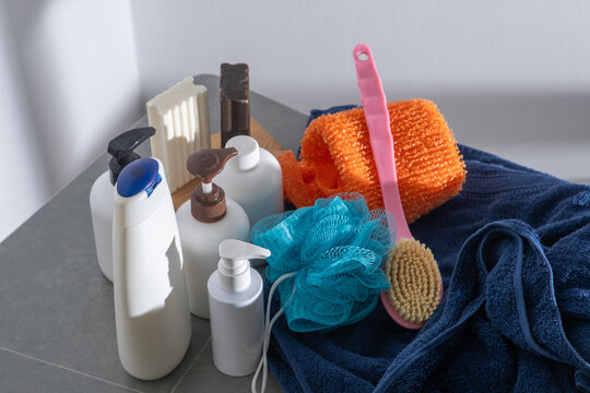 Washing body and hair in the bathroom. Towel and washcloth, Bottles of shampoo, lotion and liquid soap. Shower gel at home white background.