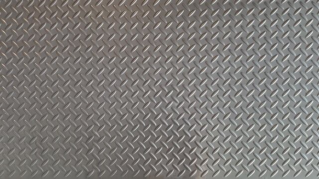 Static close-up shot of a gray diamond plate metal floor surface in a public facility with industrial non-slip texture.