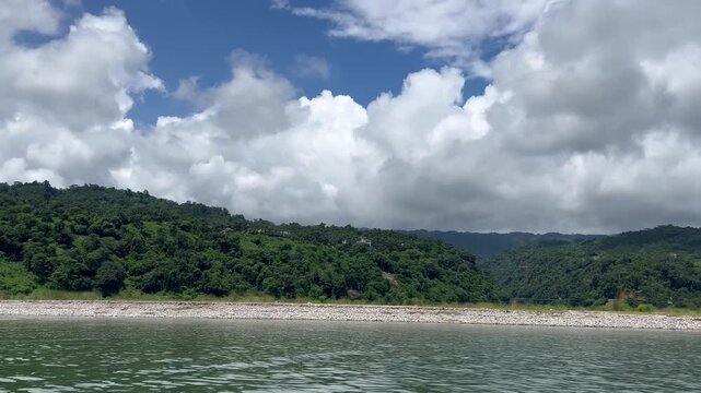 Jaflong Sylhet Stunning river landscape with lush green hills and fluffy white clouds under bright sun