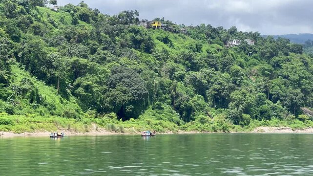 Jaflong Sylhet Boats navigate lush green riverbank on sunny day slow motion