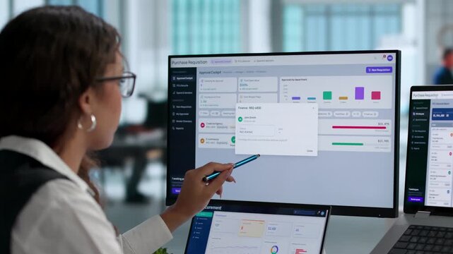 Procurement Manager Reviews Supplier Contracts Using Software