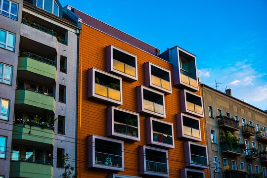 Modern apartment buildings with balconies against blue sky