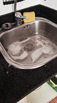 clogged kitchen sink in an apartment