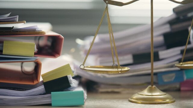 Scales of Justice with Stacks of Legal Documents in Law Office