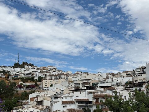 White Hillside Houses beneath a Cloud Filled Sky in Alora Spain