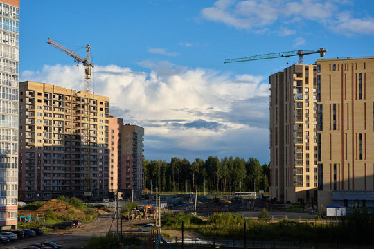 Residential construction site with tower cranes and apartment blocks.
