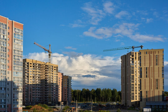 Residential construction site with tower cranes and apartment blocks.