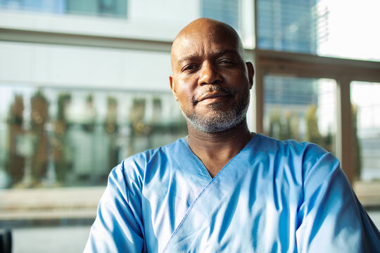 Confident male nurse portrait in modern hospital
