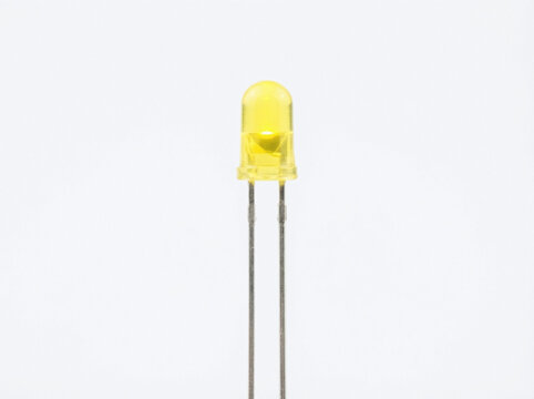 Yellow light-emitting diode with two metal leads isolated on white background