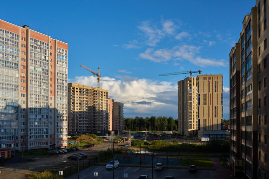 Residential construction site with tower cranes and apartment blocks.