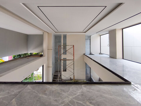 Jakarta, Indonesia  August 28 2026 Interior void area of modern two story house with natural daylight and scaffolding structure