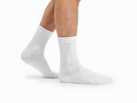 Person wearing white compression socks with gradient knit pattern for medical or athletic use