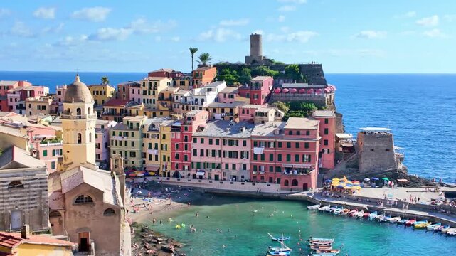 Colorful hillside buildings along a small seaside harbor. Vernazza, Italy