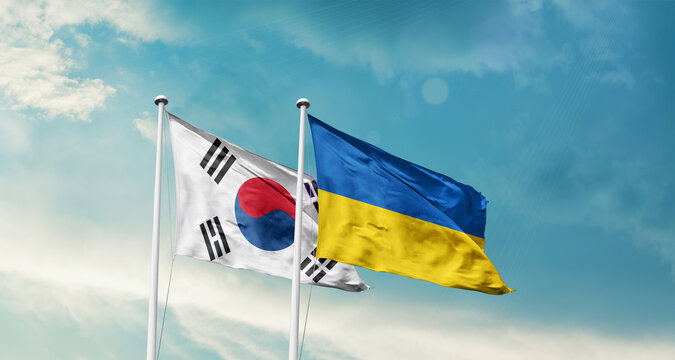 South Korea Ukraine friendship flags are waving in the sky. Two country flag for agreement or deal. Korean Ukraine national flag for commitment.
