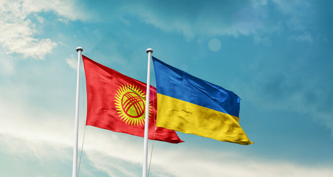 Kyrgyzstan Ukraine friendship flags are waving in the sky. Two country flag for agreement or deal. Kyrgyzstan Ukraine national flag for commitment.