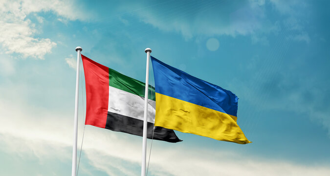 United Arab Emirates Ukraine friendship flags are waving in the sky. Two country flag for agreement or deal. UAE Ukraine national flag for commitment.