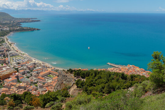 Aerial view of a picturesque coastal town with a harbor and blue sea