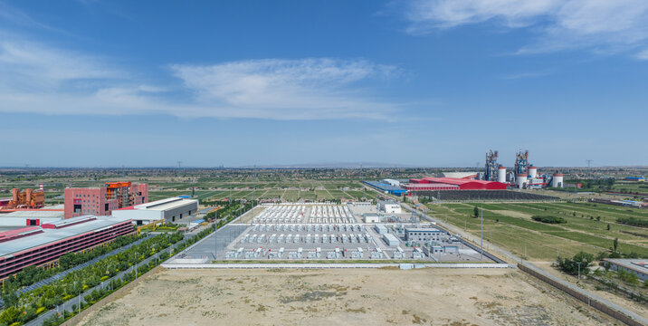Aerial View of Large-Scale Battery Energy Storage Power Station Next Industrial Plant In Rural Area