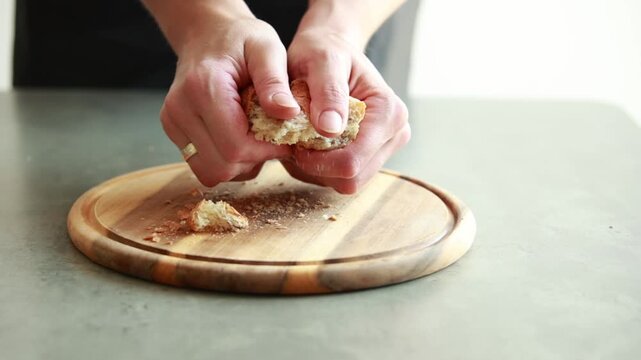 Woman Hands Breaking Old Bread into Pieces on a Cutting Board Close Up Video