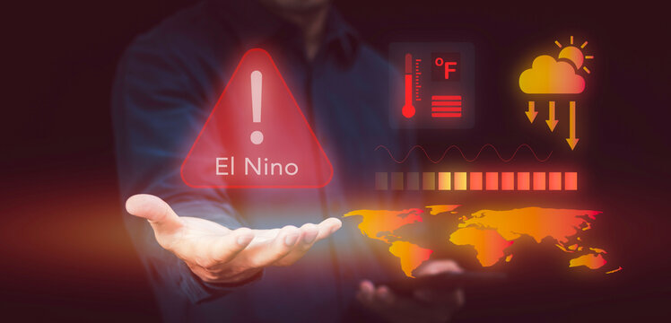 Hand holding El Nino warning sign concept. Global warming, climate change, high temperature thermometer, drought risk, world heat map, heatwave, and extreme weather forecast.